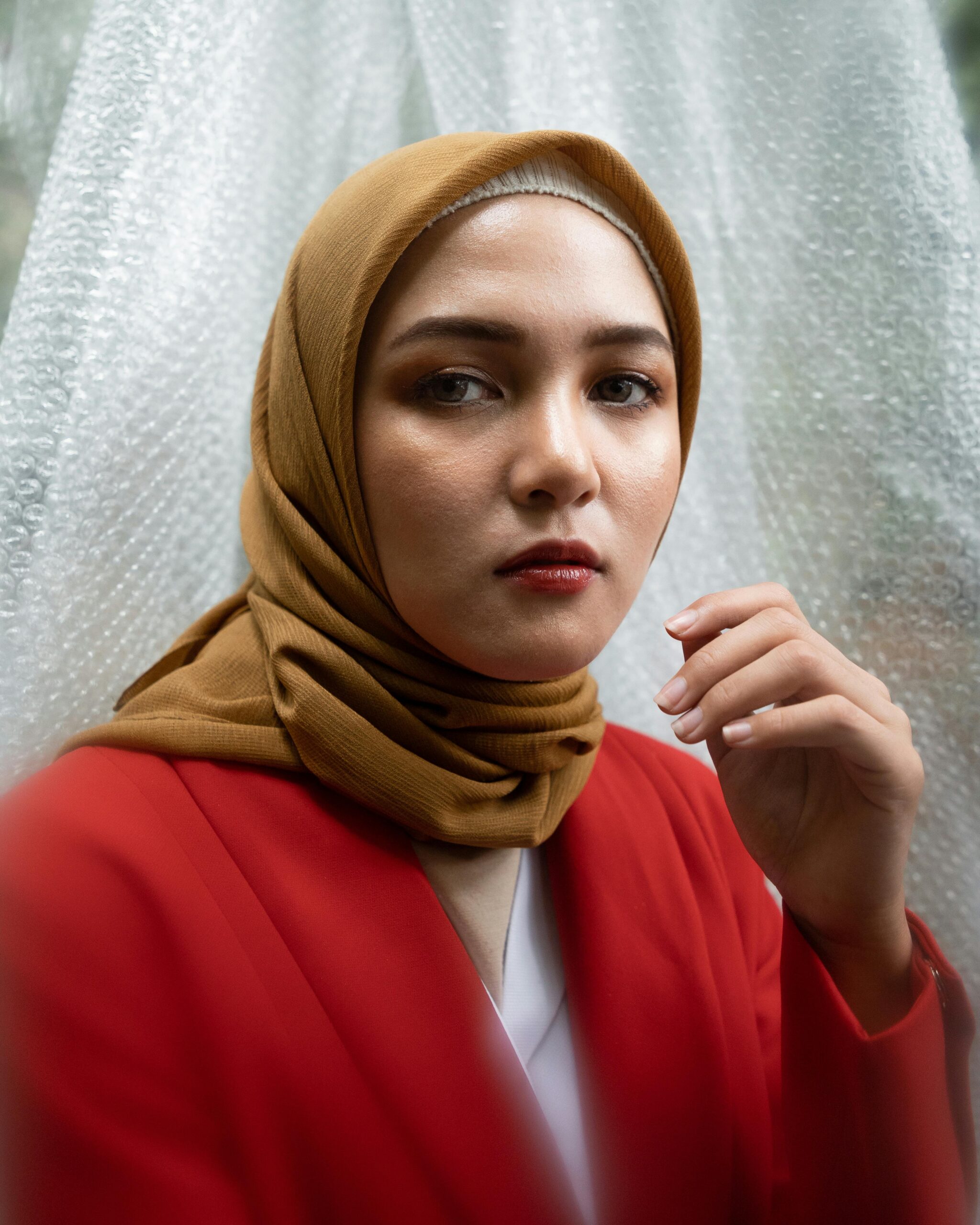 Young woman in a stylish hijab portrayed in an outdoor setting. Fashionable and elegant.